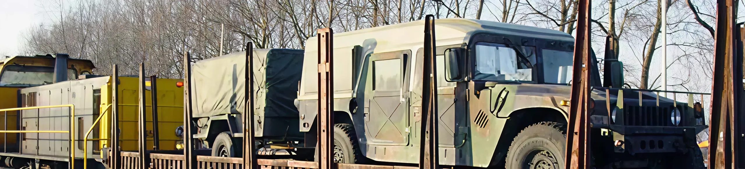 military vehicles being transported in a train