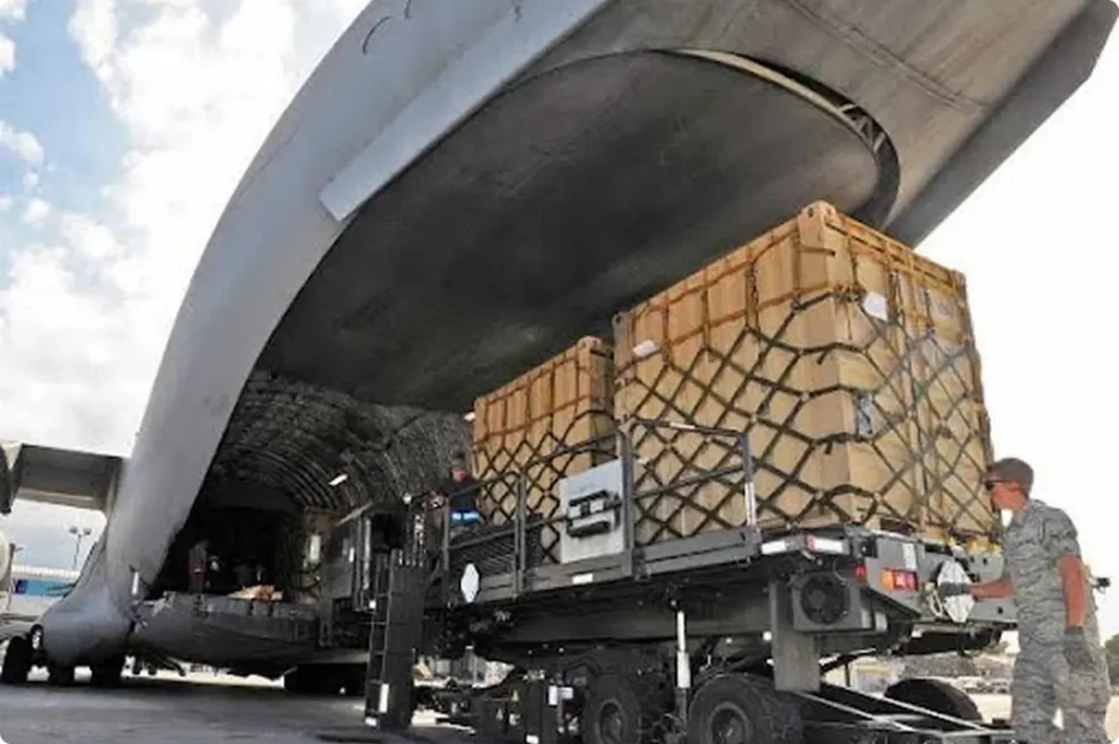 back of large cargo plane with pallets being loading inside