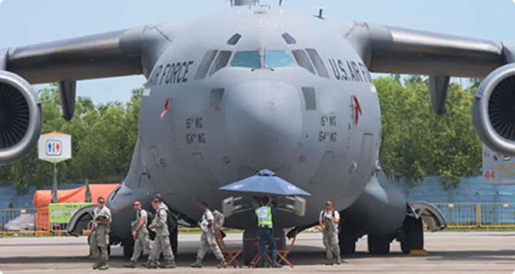 Military men walking in front of a cargo plane