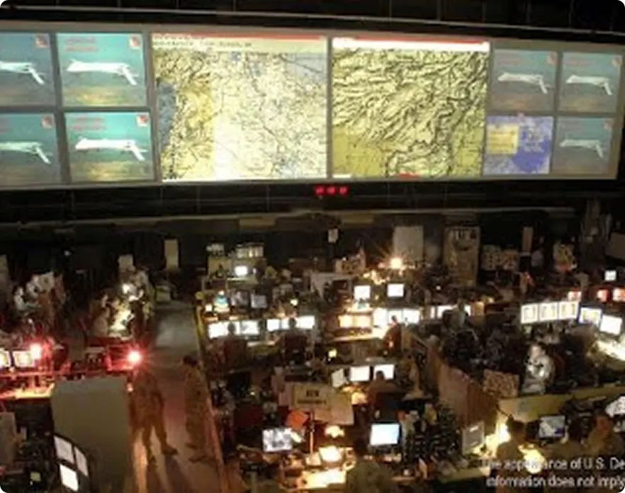 war room with multiple large screens on the wall